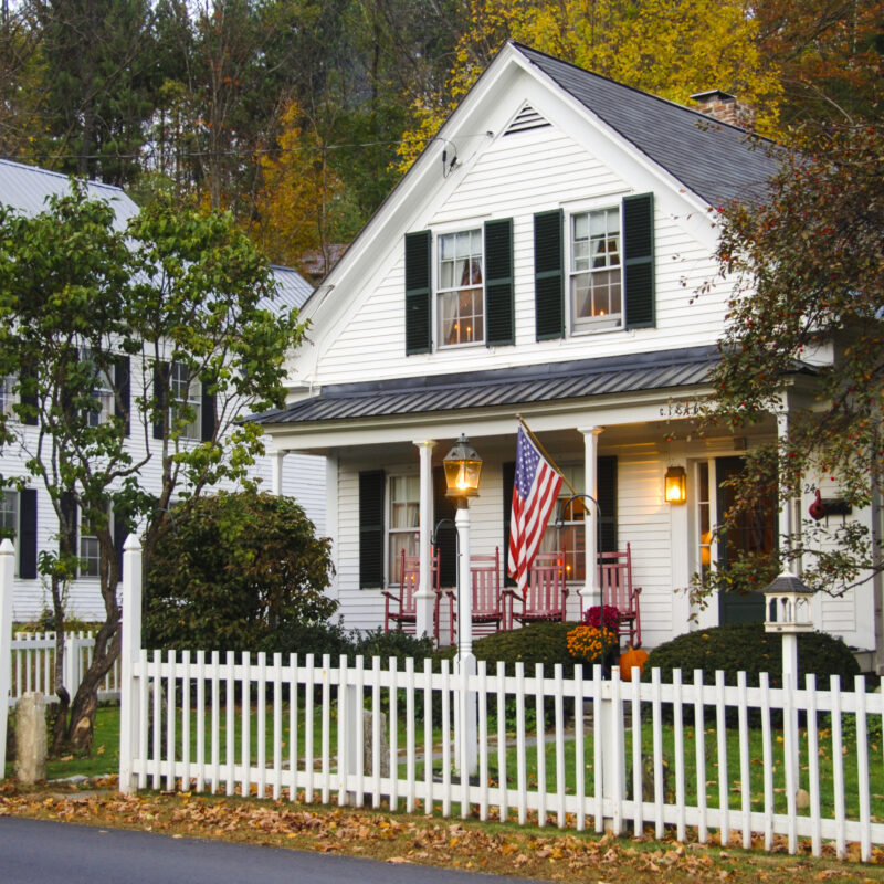 White house with a white picket fence in front
